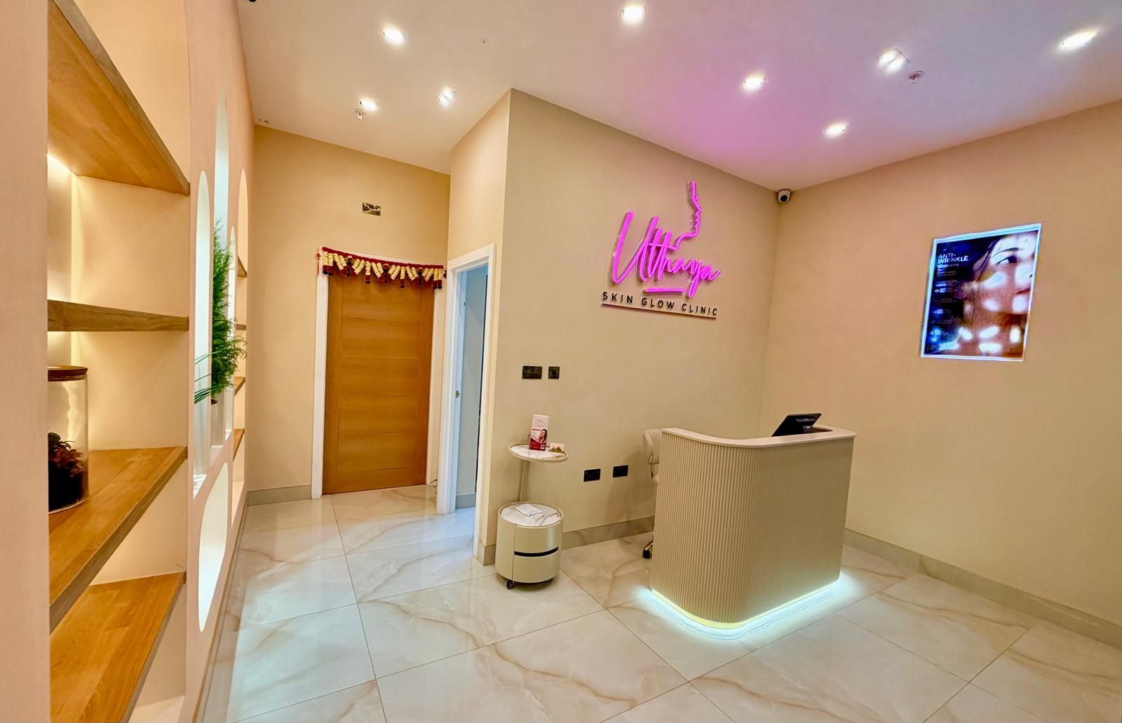 Reception area of Uthaya Skinglow Clinic in East Ham with neon clinic sign